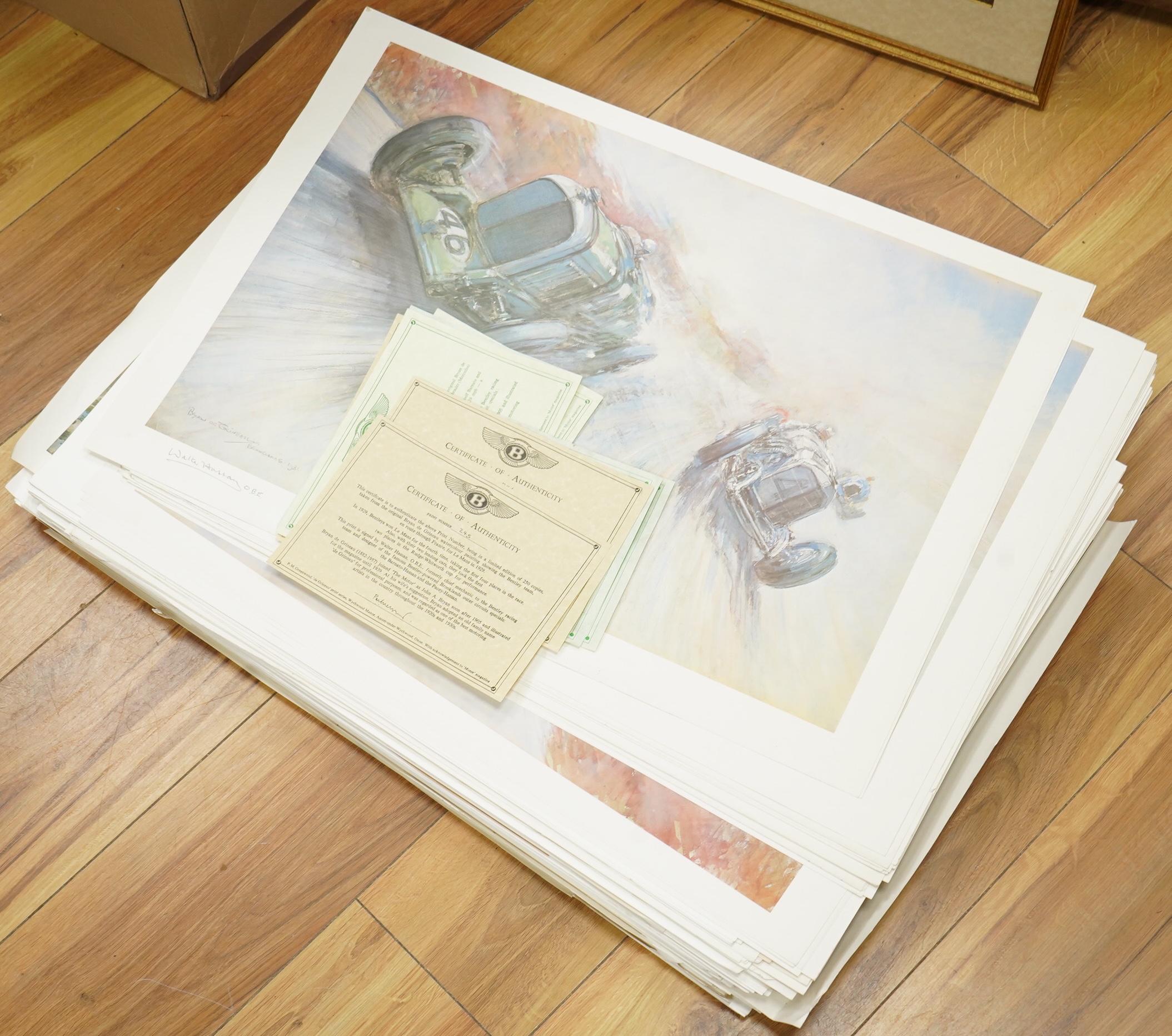 Two framed and signed motor racing lithographs by Anthony Heal and Walter Hassan of Le Mans and Brookslands racing scenes, the largest frame 61.5 x 76cm, together with a folio containing a large number of unframed simila
